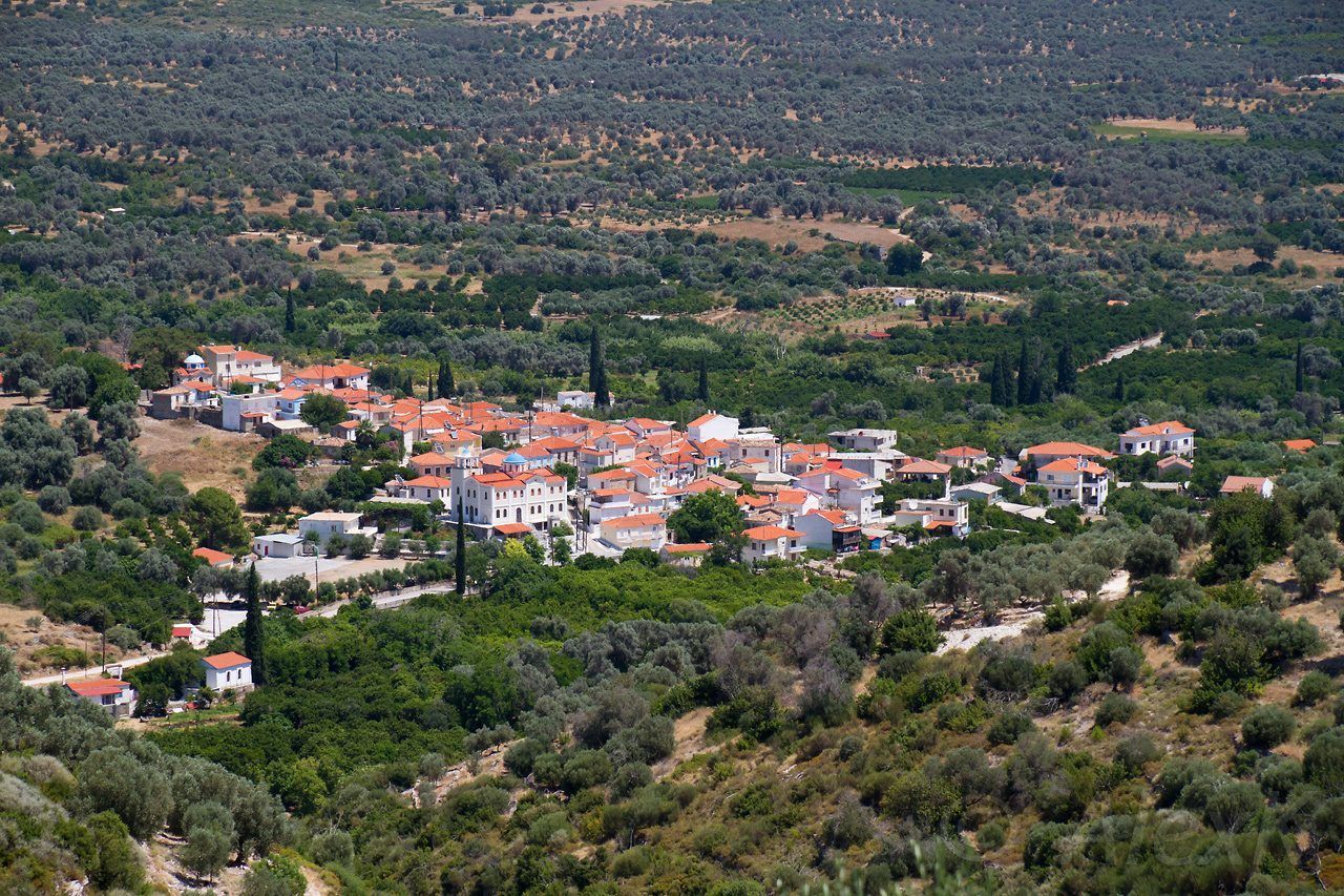Myloi village in Samos with stone houses, historic mills and green landscape.