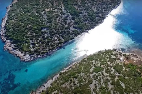Kasonisi on Samos with shallow turquoise waters in the Blue Lagoon strait