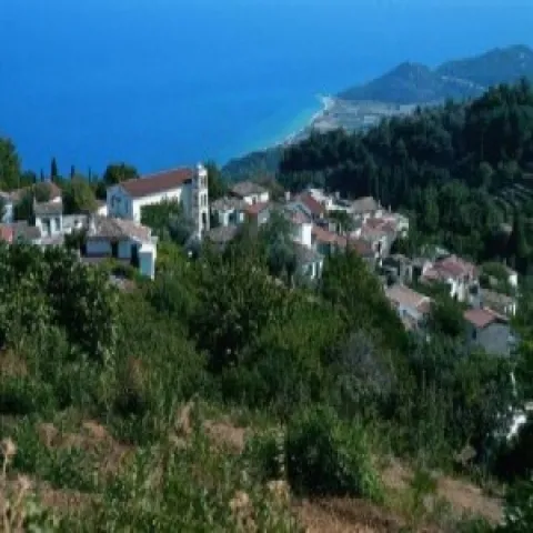 Aerial view of Stavrinides, Samos, with traditional houses and the sea in the background.